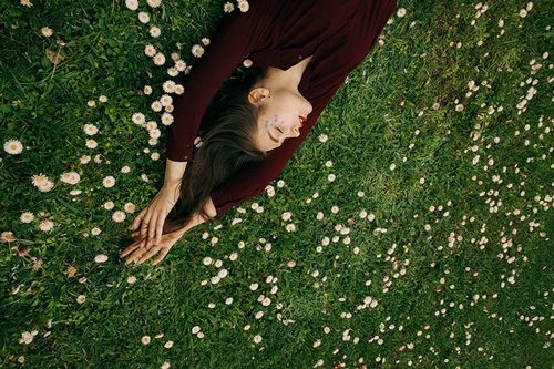 woman sleeping on grass